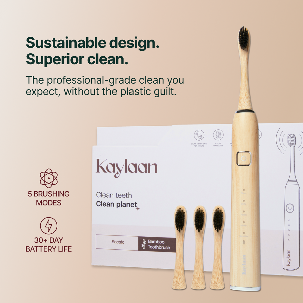 Kaylaan electric bamboo toothbrush with packaging and additional brushes on a beige background