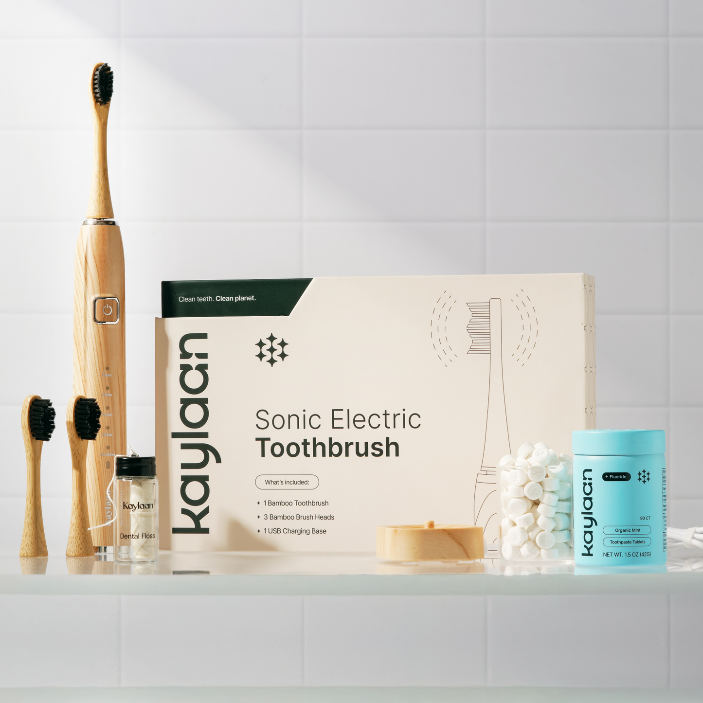 Kaylaan eco-friendly oral care bundle including bamboo sonic electric toothbrush, fluoride toothpaste tablets, mouthwash tablets, and dental floss