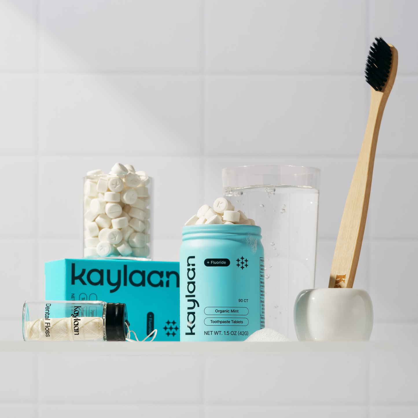 Kaylaan eco-friendly oral care essentials bundle with fluoride toothpaste tablets, dental floss, mouthwash tablets, and bamboo toothbrush