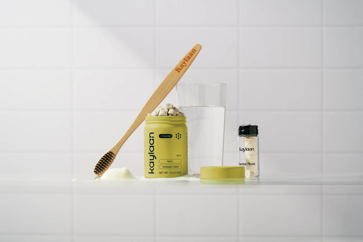 Kaylaan plastic free toothpaste tablets tin with a bamboo toothbrush and sustainable dental floss