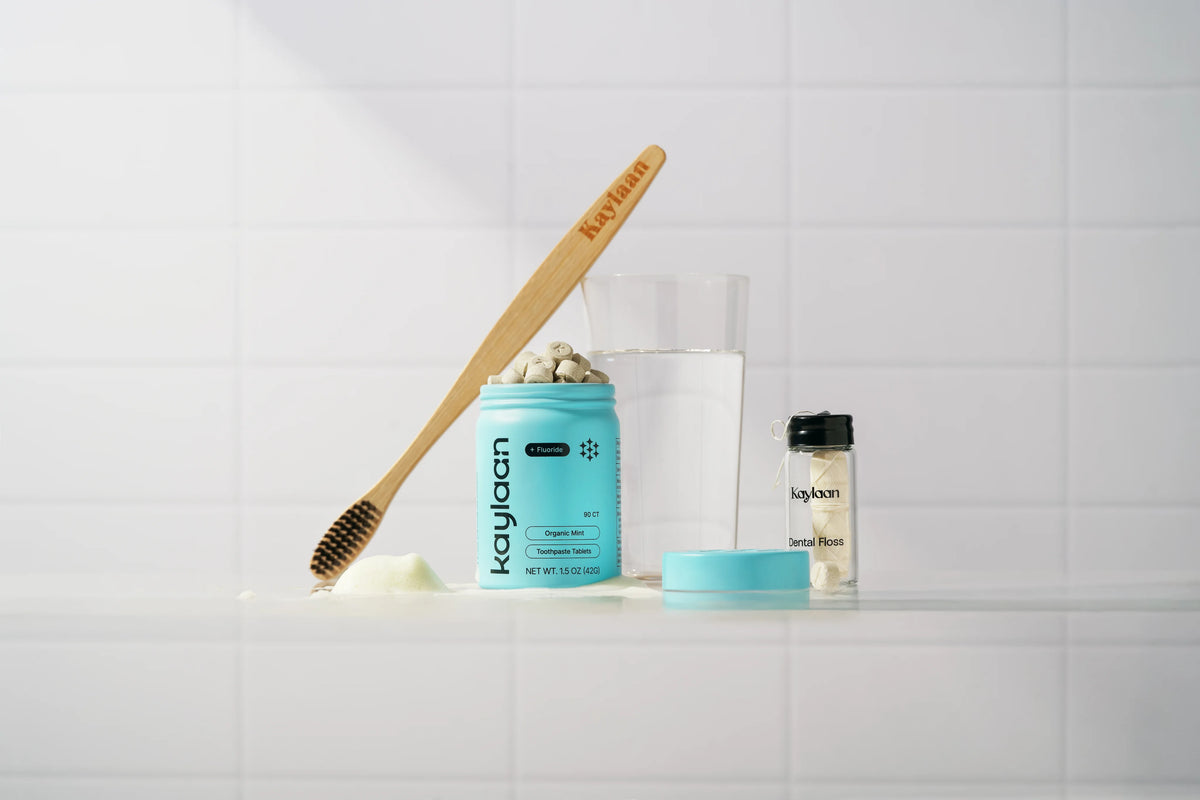 Kaylaan plastic free toothpaste tablets tin with a bamboo toothbrush and sustainable dental floss