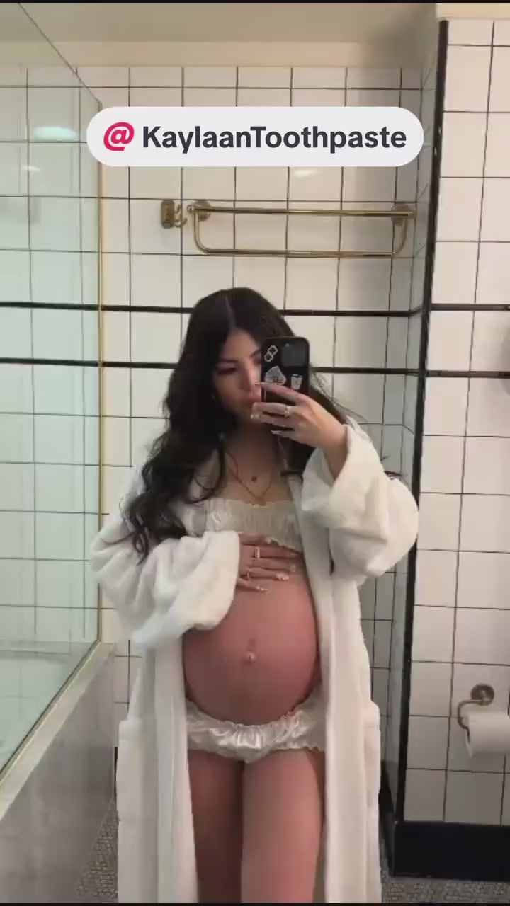 A pregnant woman sharing her morning routine in a bathroom with a text overlay reading '@KaylaanToothpaste'